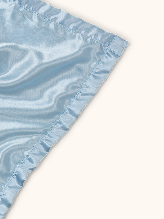 Mr. Happy security blanket showing reverse satin side