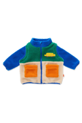 A baby sherpa zip-up vest with a color-blocked design featuring blue sleeves and collar, a green upper chest, a cream lower body, and two orange front pockets. A small yellow car patch is on the left chest.