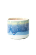 Ceramic mug with blue and white gradient on a white background