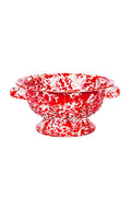 Red and white speckled colander on a white background