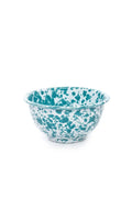 Teal and white splatter textured bowl on a white background