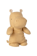 Beige plush hippo toy on a white background