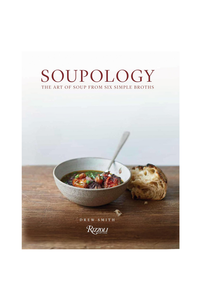 Book cover of 'Soupology' with a bowl of soup and bread on a wooden surface.