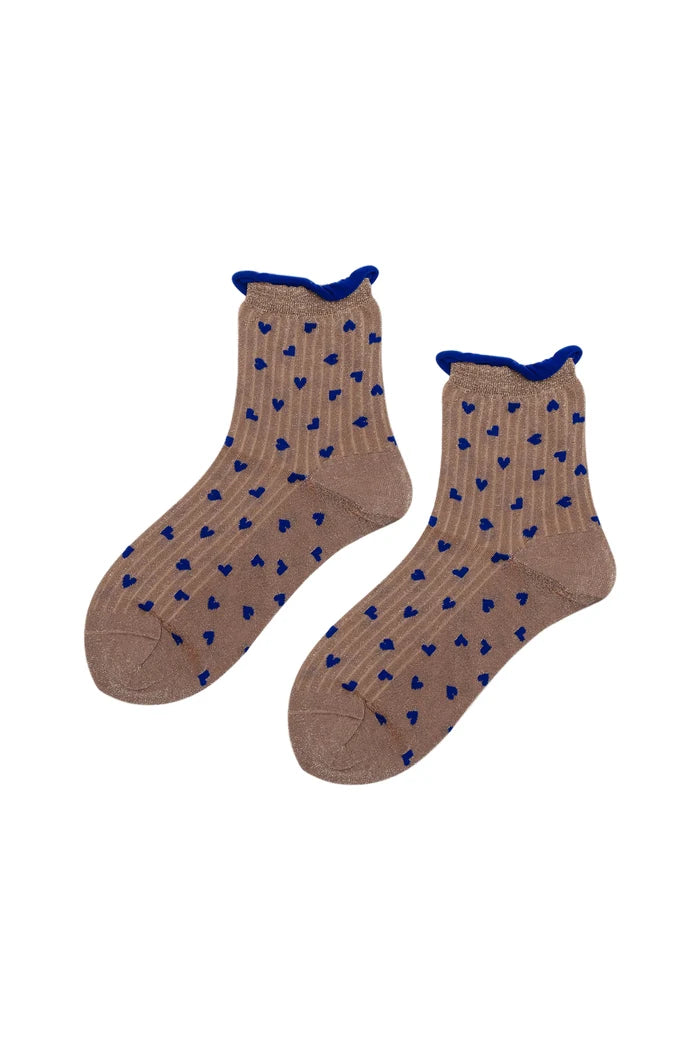 A pair of ankle socks in a warm taupe-brown color, featuring a pattern of small blue hearts and a solid blue cuff trim, displayed against a clean white background.