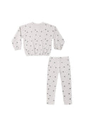 A two-piece children's set featuring a long-sleeve top and matching pants in a light off-white fabric with a small black star pattern, laid flat on a white background.