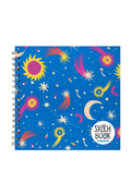 A spiral-bound sketch book with a vibrant blue cover decorated with colorful celestial illustrations, including stars, moons, and suns, with a white circular logo in the bottom right corner.