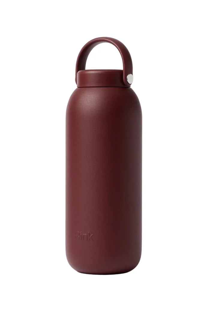 Red water bottle with a cap on a white background