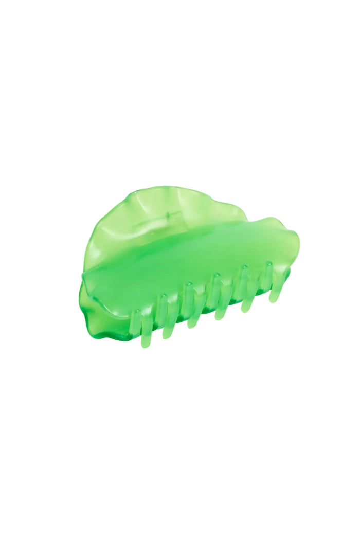 Green plastic claw clip on a white background