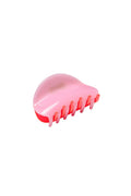 Bright pink and red hair claw clip on white background