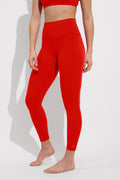 Person wearing red leggings on a white background