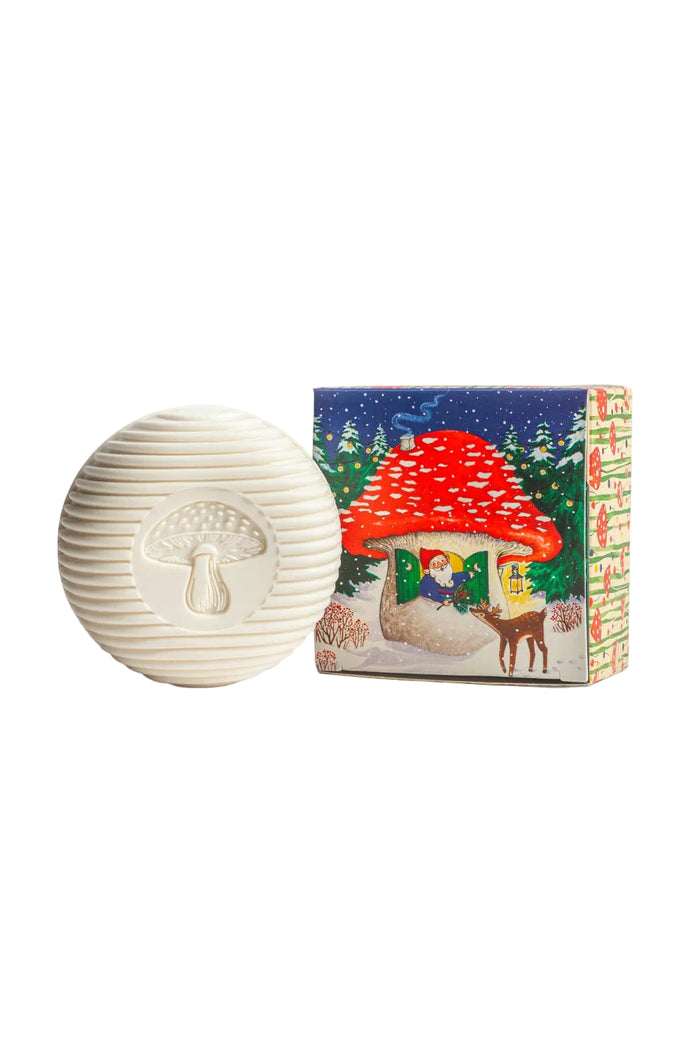 White textured sphere with mushroom design next to a colorful box featuring a fairy tale scene.