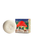 White textured sphere with mushroom design next to a colorful box featuring a fairy tale scene.
