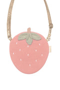 Pink strawberry-shaped pouch with a green leaf on a white background