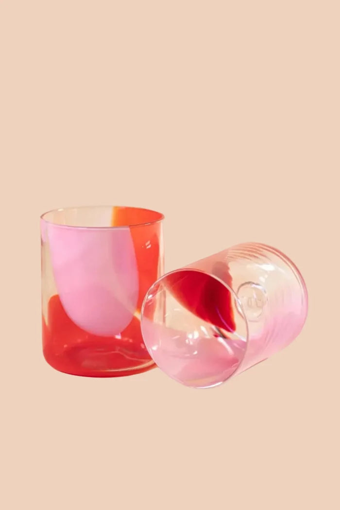 Two colorful glasses on a pink background