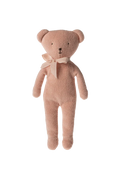 Pink teddy bear with a bow tie against a striped background