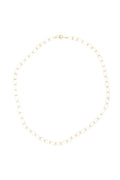 A delicate gold chain necklace with small, evenly spaced white pearl-like beads, arranged in a circle on a solid white background.