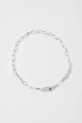Silver chain necklace on a light gray background