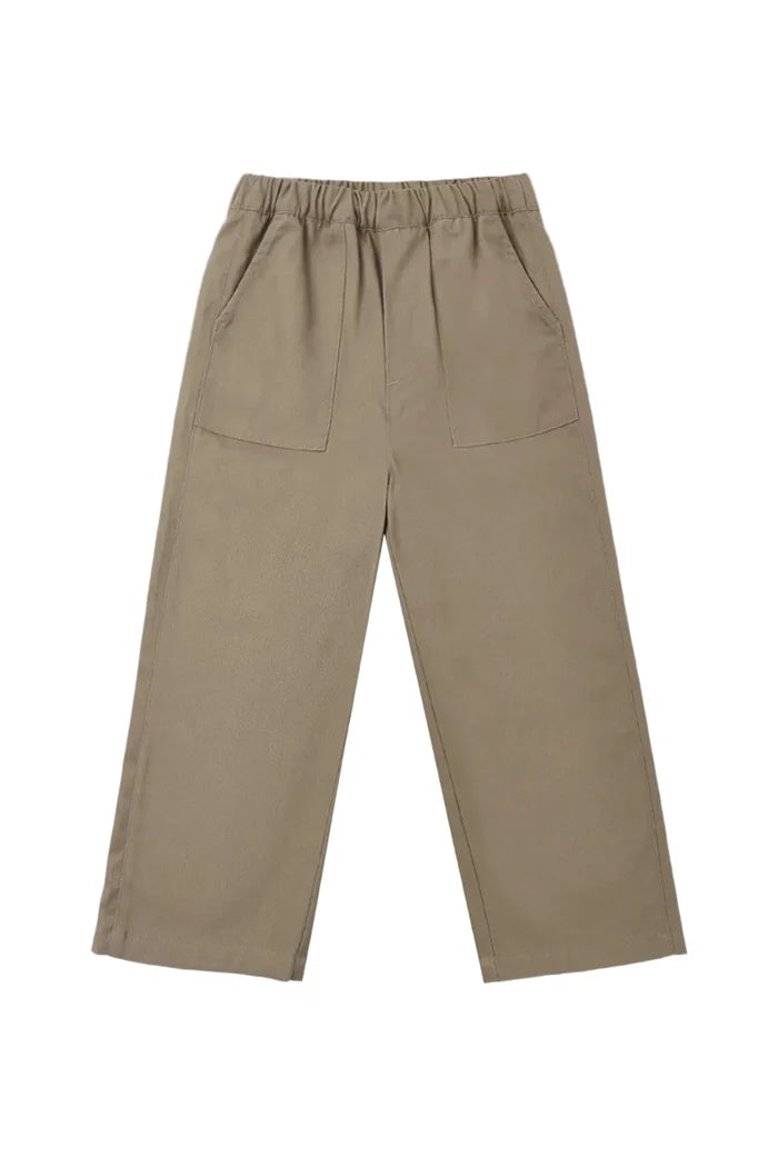 A pair of wide-leg trousers in a muted taupe-brown color, featuring an elastic waistband and two large front patch pockets, shown flat on a light gray background.