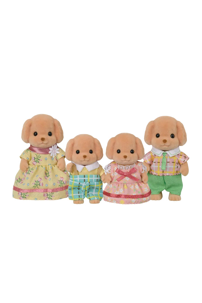 Four toy dogs in colorful outfits on a white background