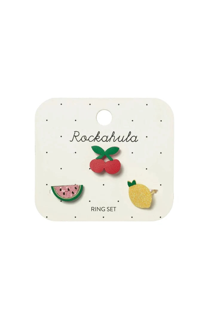 A watermelon, cherry, and lemon ring fixed onto paper packaging on white background