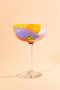 Glass coupe with colorful swirls and smiley faces