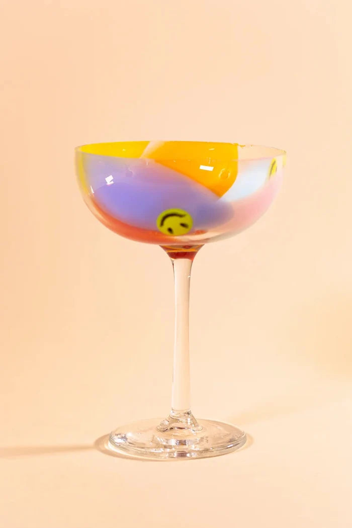 Glass coupe with colorful swirls and smiley faces
