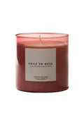 Pink candle labeled 'Voile en Rose' on a beige background
