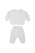 A two-piece baby loungewear set consisting of a long-sleeve sweatshirt and matching pants in white, both covered in a small dark gray star pattern.