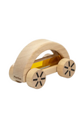 A wooden toy car with a natural light wood body, black wheel spokes, and a translucent amber-colored window, shown on a plain white background. The brand name 'Plan Toys' is visible on the side.