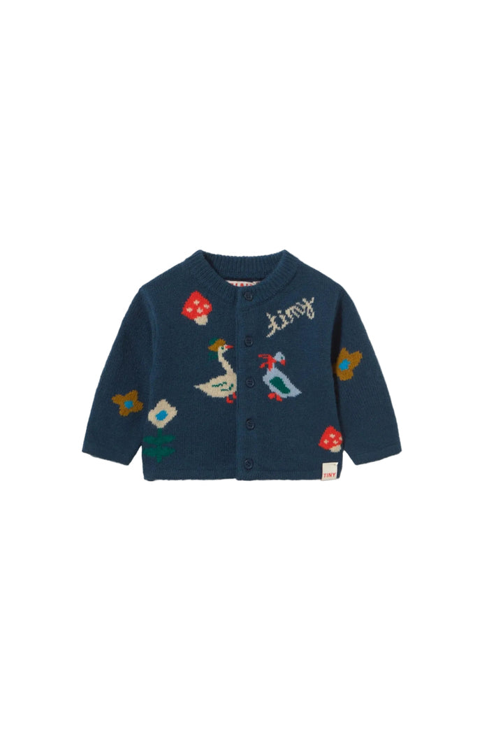 A navy blue long-sleeve cardigan for toddlers, featuring colorful embroidered motifs including a goose, mushrooms, a duck, and a bird, with the brand name 'tiny' embroidered on the chest.