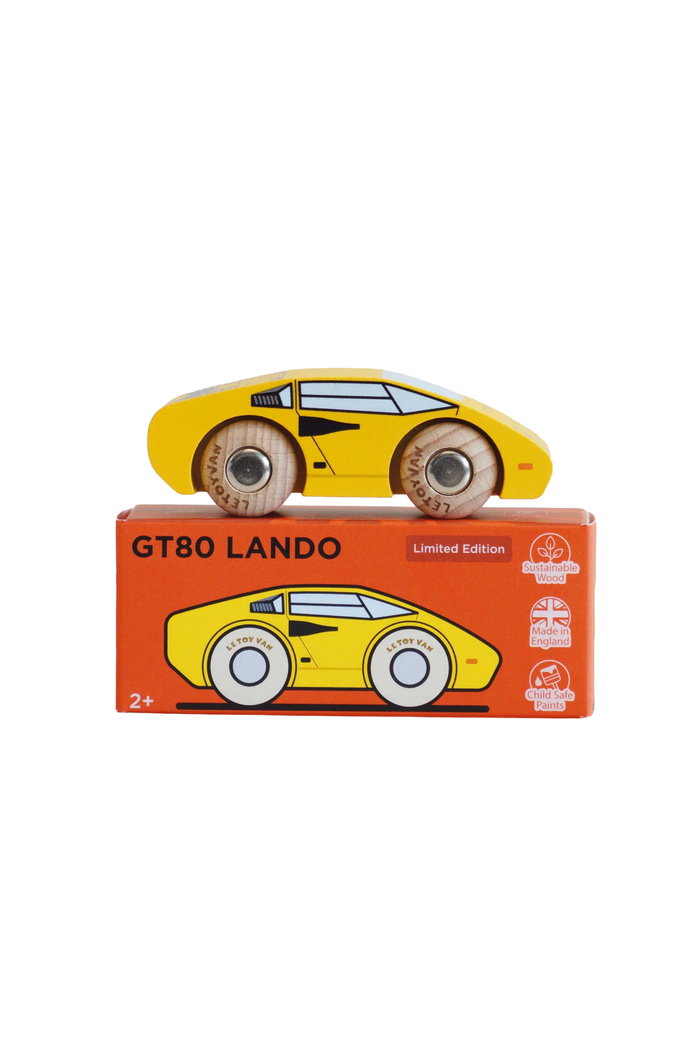 A yellow wooden toy sports car with brown wheels sits on top of its orange retail box labeled GT80 LANDO Limited Edition, photographed on a plain white background.