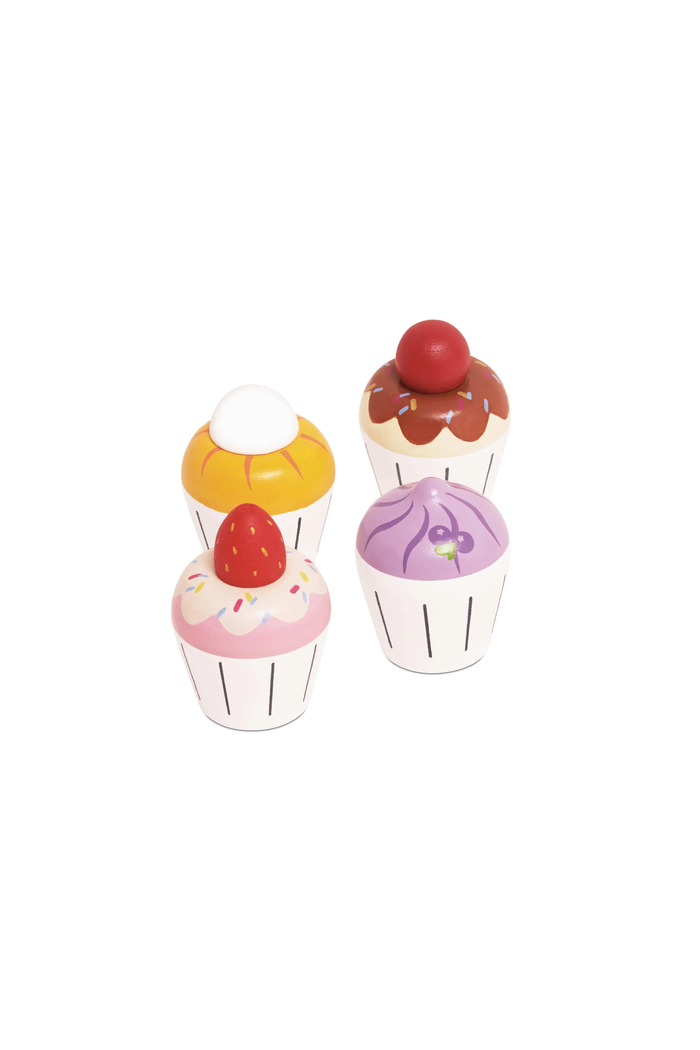 Four small toy cupcake figurines in different colors, including yellow, brown, pink, and purple, arranged on a plain white background.