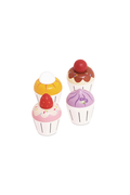 Four small toy cupcake figurines in different colors, including yellow, brown, pink, and purple, arranged on a plain white background.