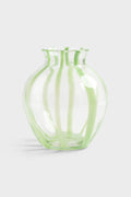 Glass vase with green stripes on white background