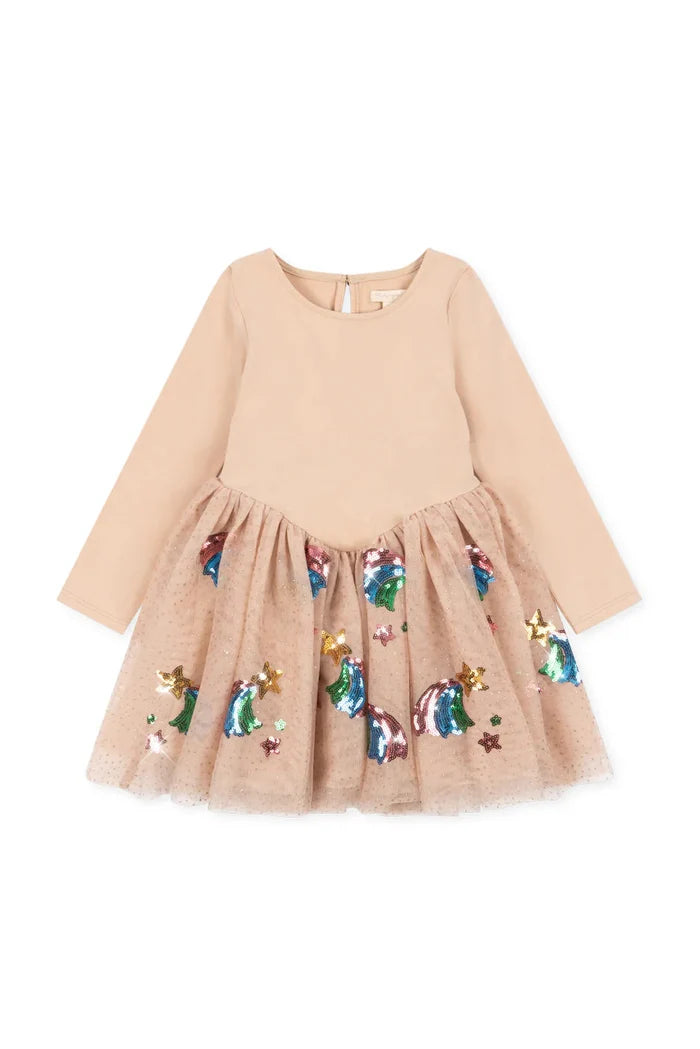 A long-sleeve children's dress in light beige with a solid upper bodice and a tulle skirt decorated with colorful star appliqués, shown on a plain white background.